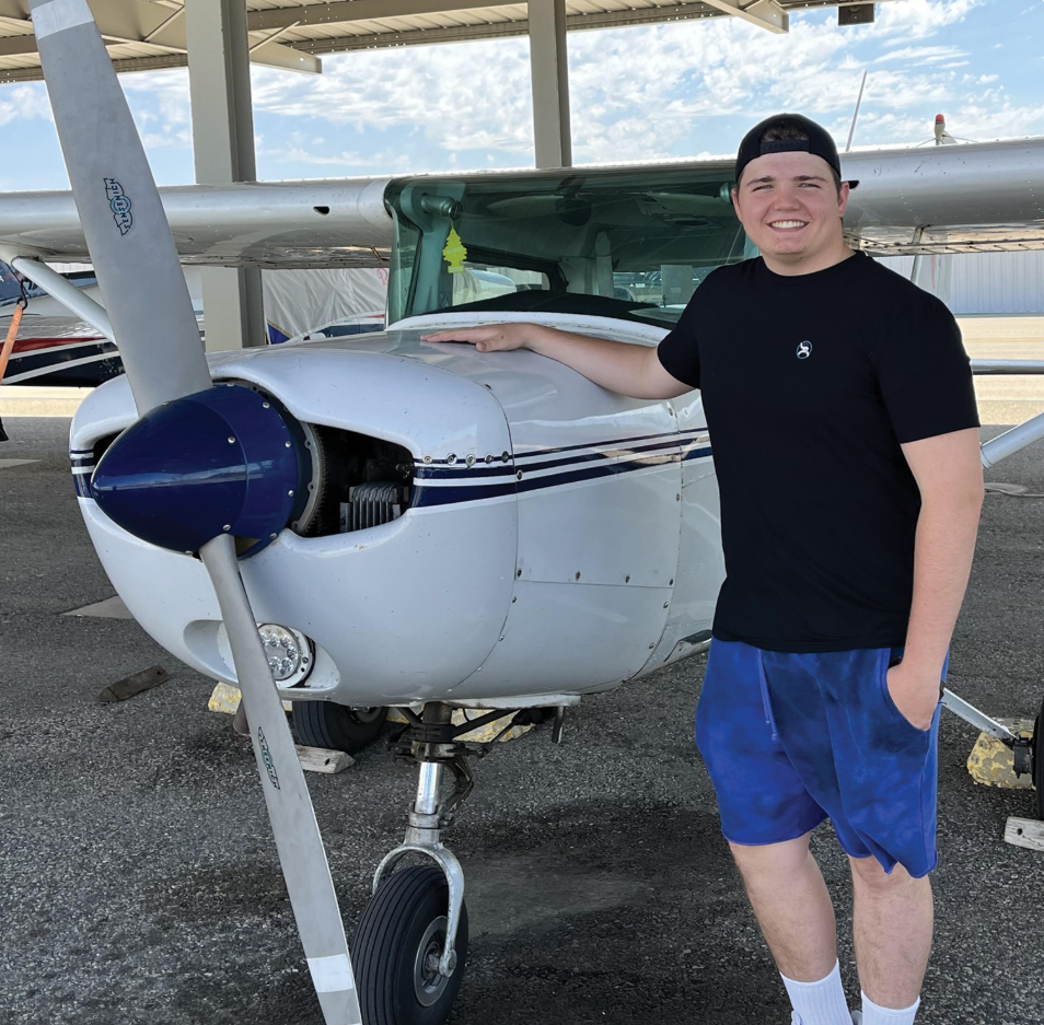 Aerotech student smiling next to a Cessna